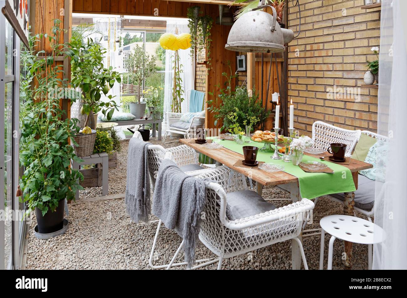 Orangery - glass enclosed seating area with plants Stock Photo