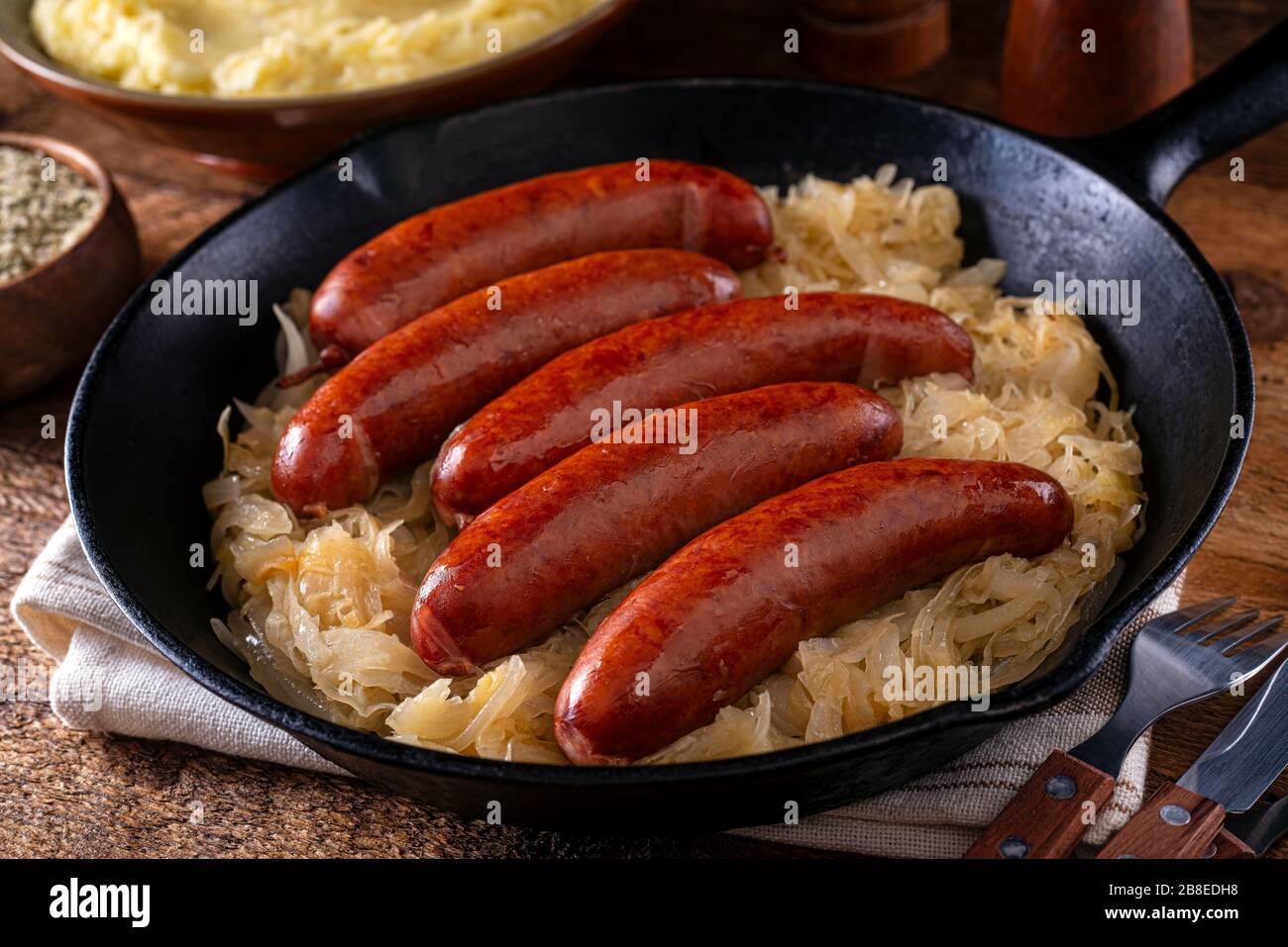 A skillet of delicious smoked sausage and sauerkraut. Stock Photo