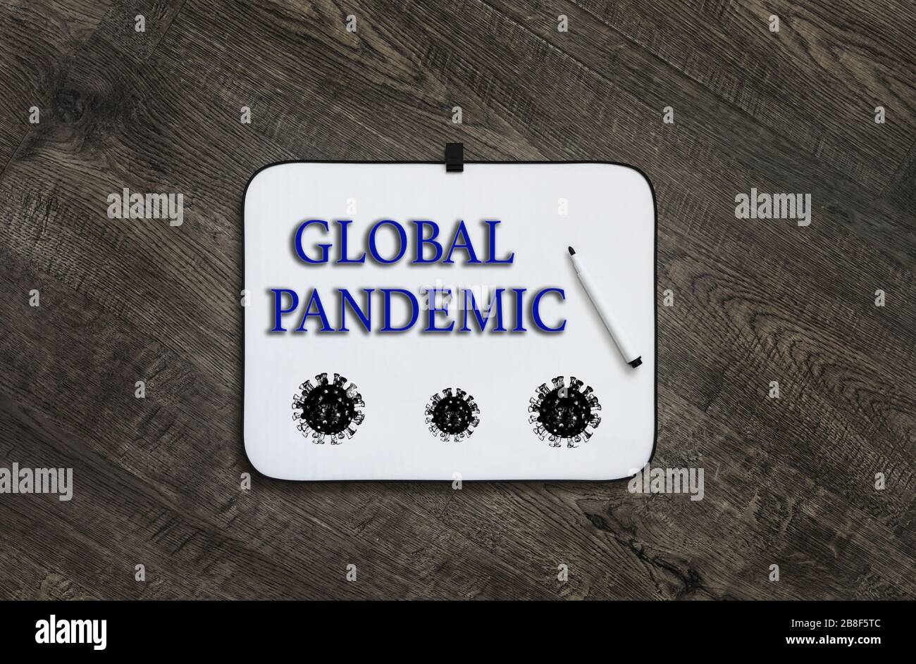 White board with the words GLOBAL PANDEMIC on a dark wooden background.Coronavirus COVID-19 concept. Dangerous chinese nCoV coronavirus outbreak. Stock Photo