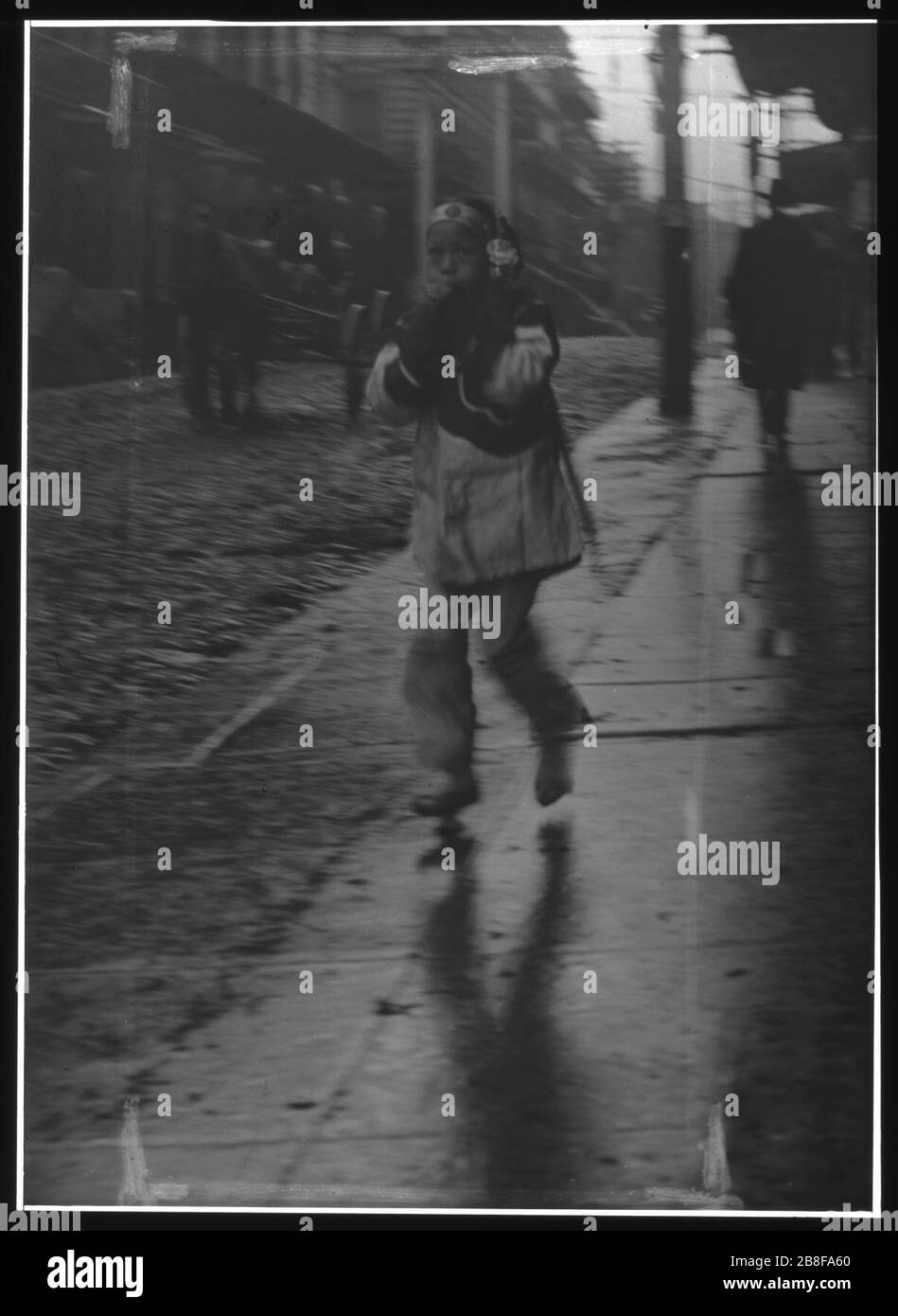 Girl running down a street, Chinatown, San Francisco Stock Photo