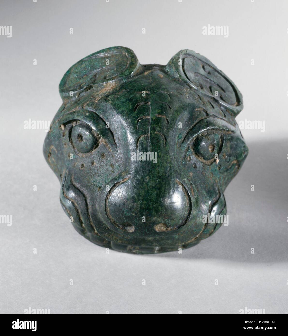 'Fitting (Shi) in the Form of a Feline Head; China, Late Shang dynasty, late Anyang phase or early Western Zhou Dynasty, about 1100-950 B.C.  Sculpture Cast bronze 2 1/4 x 2 in. (5.72 x 5.08 cm) Gift of Carl Holmes (64.12.4) Chinese Art; between circa 1100 and circa 950 B.C.; ' Stock Photo
