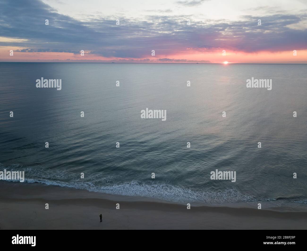 Arial view of social distancing during an Atlantic Ocean sunrise. Stock Photo