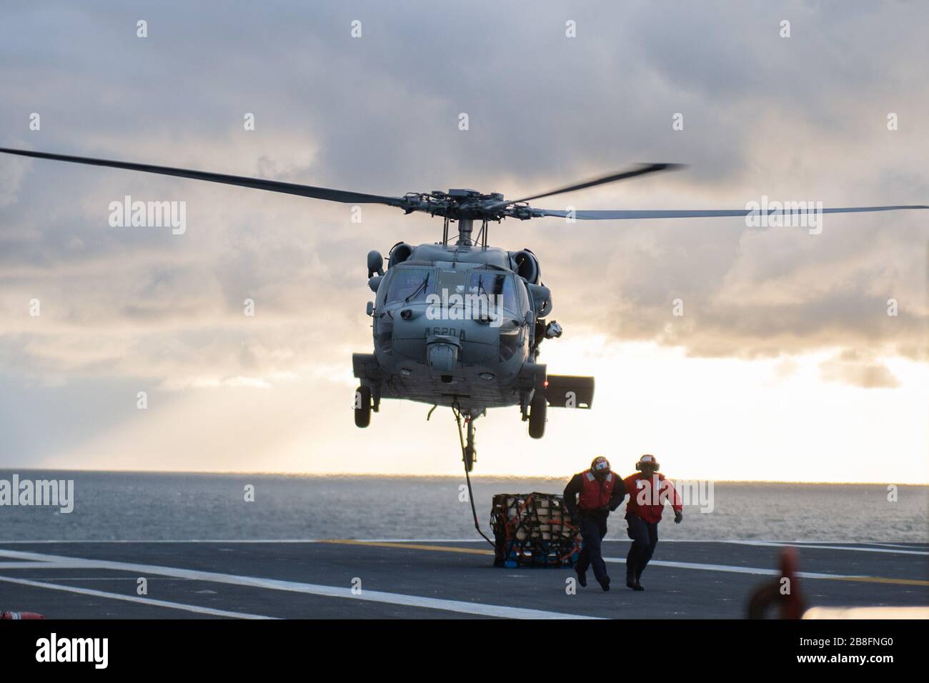 An MH-60S Seahawk, attached to Helicopter Sea Combat Squadron (HSC) 9, conducts a vertical replenishment (VERTREP) exercise with the aircraft carrier USS Gerald R. Ford (CVN 78) in the Atlantic Ocean, March 15, 2020. HSC 9 is currently underway with the Ford supporting flight operations. (U.S. Navy photo by Mass Communication Specialist 3rd Class Rebekah M. Rinckey) Stock Photo