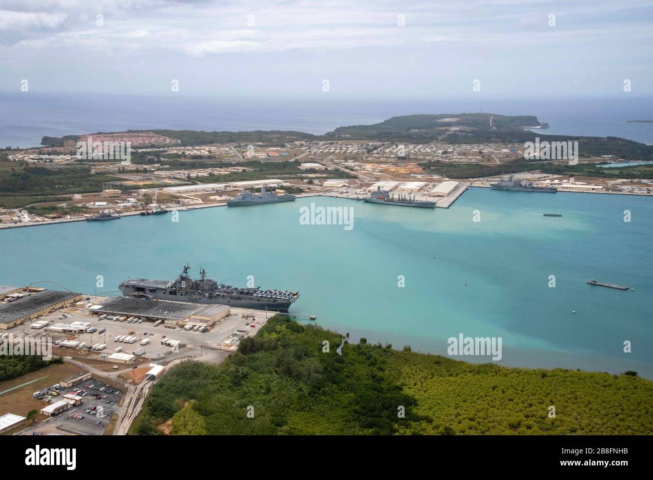 200321-N-RU810-1119 NAVAL BASE GUAM (March 21, 2020) Amphibious assault ship USS America (LHA 6), San Antonio-class dock landing ship USS Green Bay (LPD 20) and Whidbey Island-class dock landing ship USS Germantown (LSD 42), all part of the America Expeditionary Strike Group, operate from Naval Base Guam with USNS Rappahannock (T-AO 204). Operating in the U.S. 7th Fleet area of operations, the America ESG-31st Marine Expeditionary Unit team of 4,500 Sailors and Marines is prepared to conduct missions across the full spectrum of military operations. (U.S. Navy photo by Mass Communication Specia Stock Photo