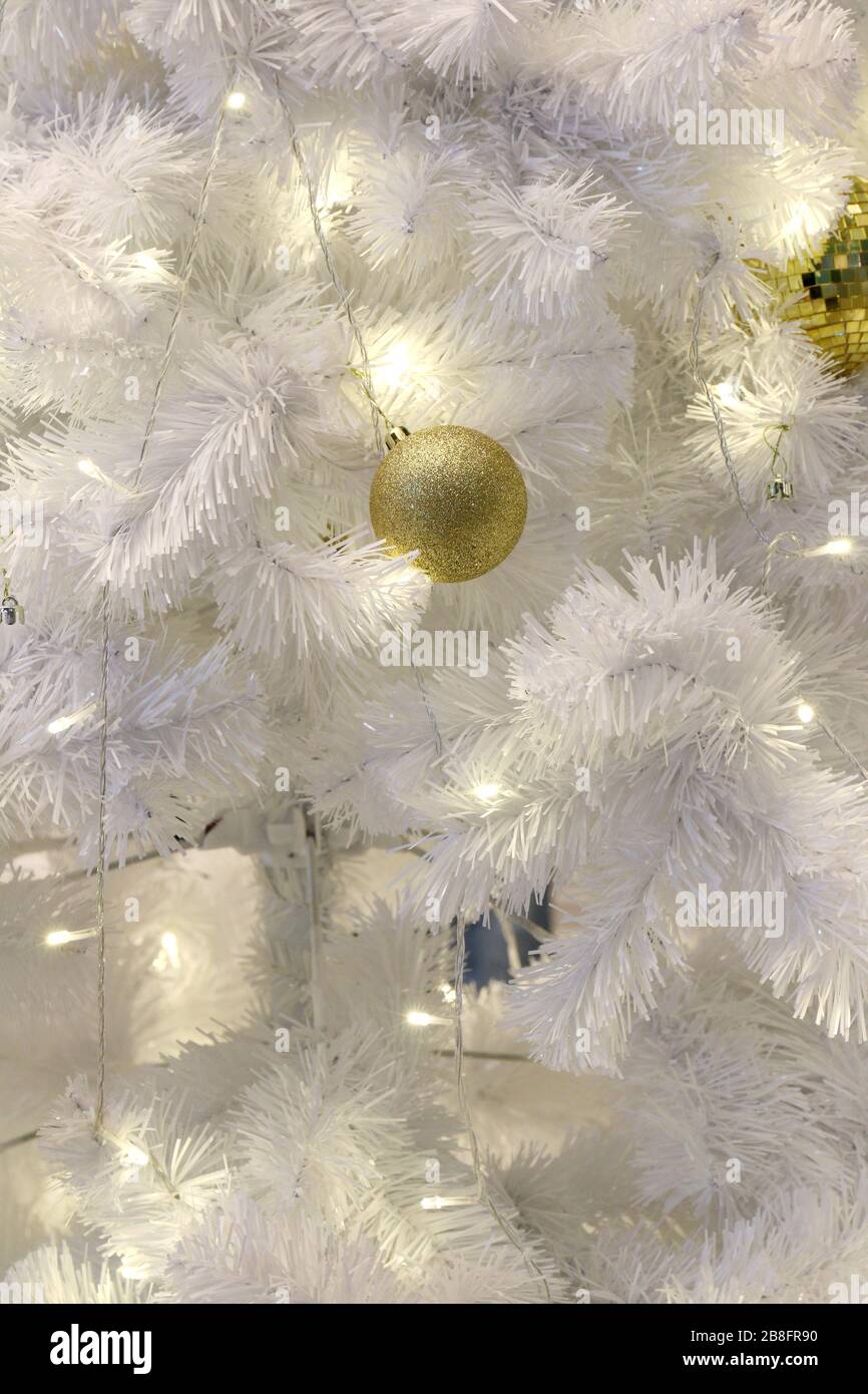 Golden ball on White Christmas tree background decoration (selective focus) Stock Photo