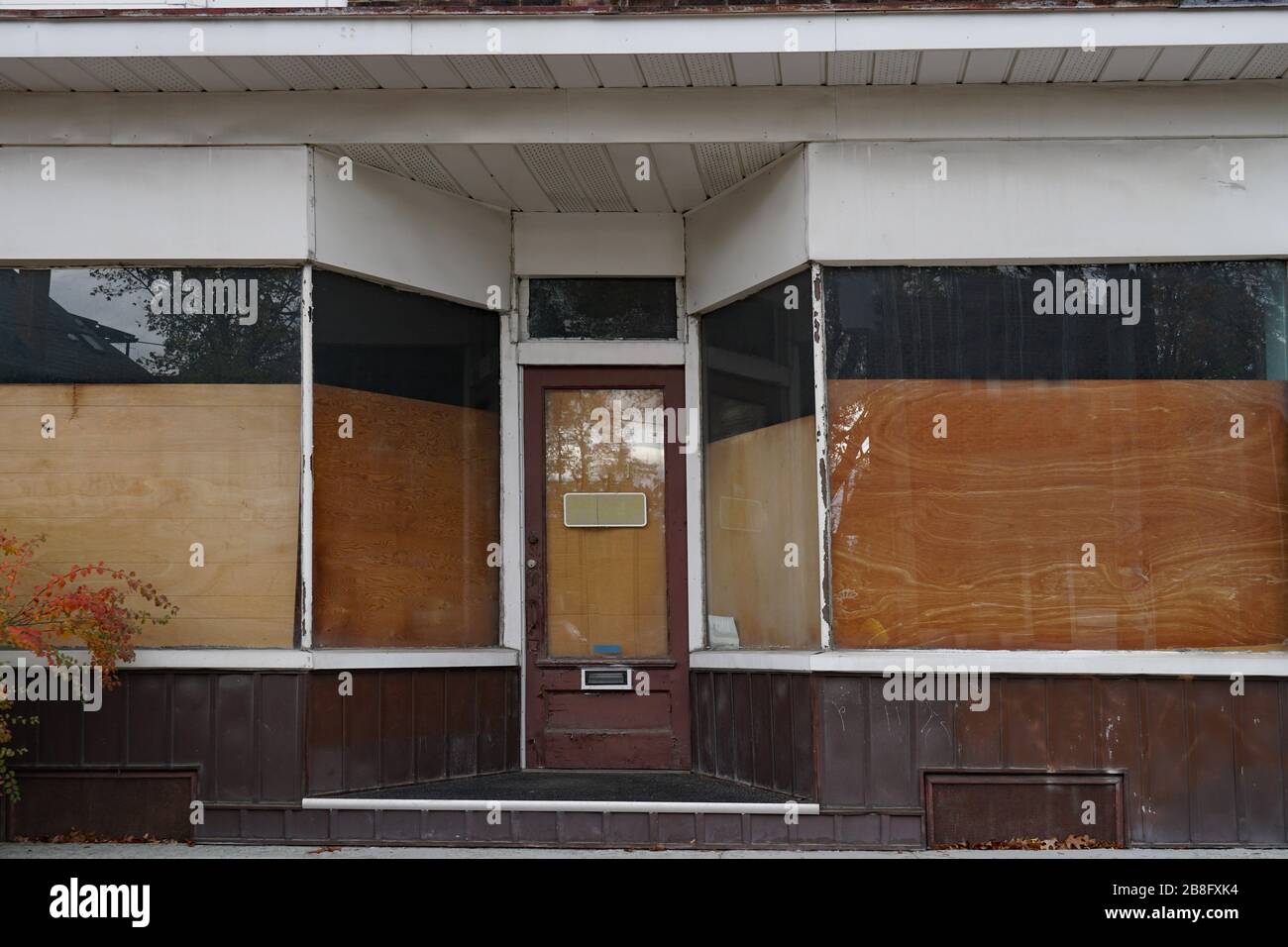 Derelict storefront with boarded up windows Stock Photo