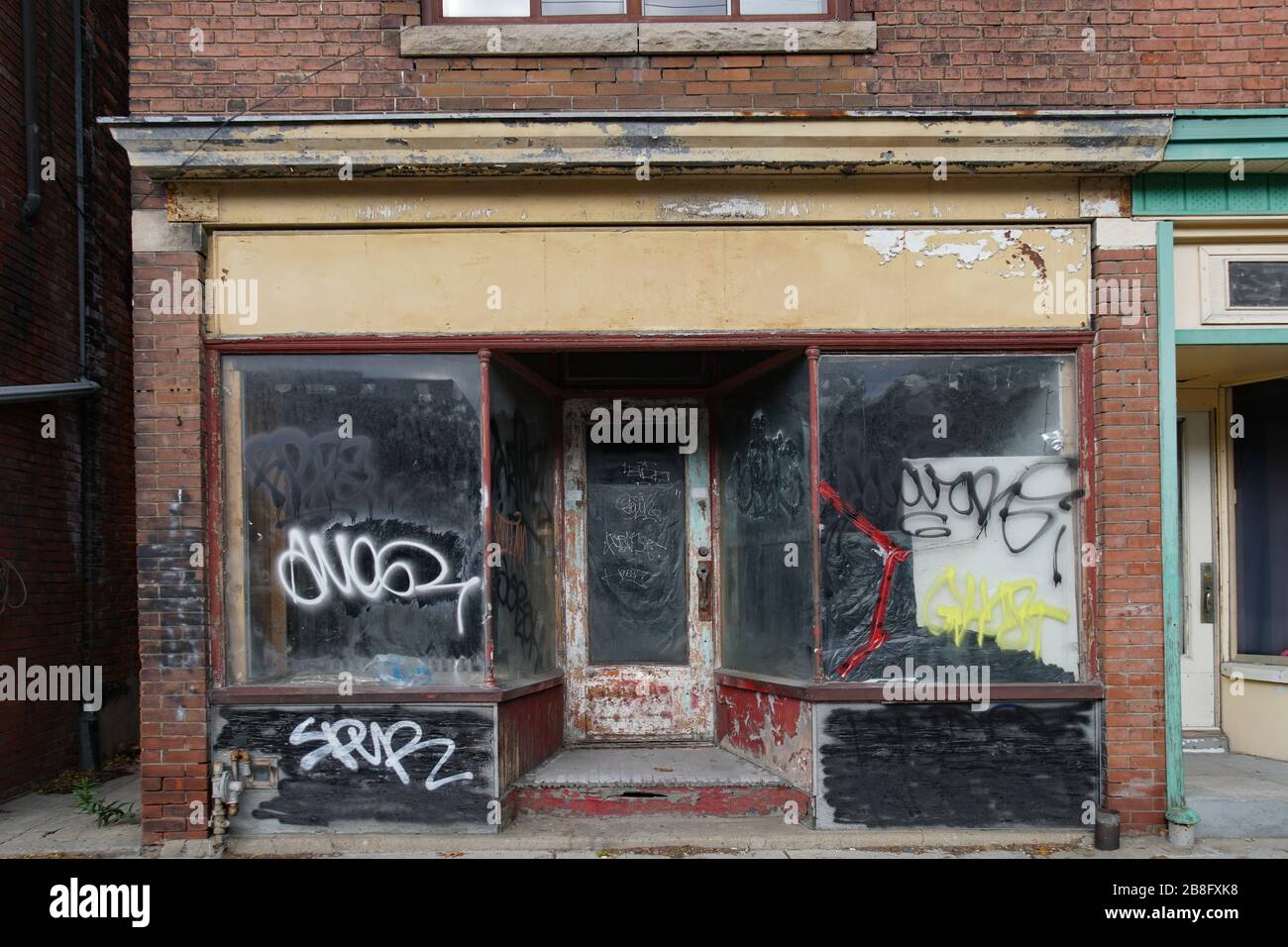 Derelict old storefront with graffiti Stock Photo Alamy