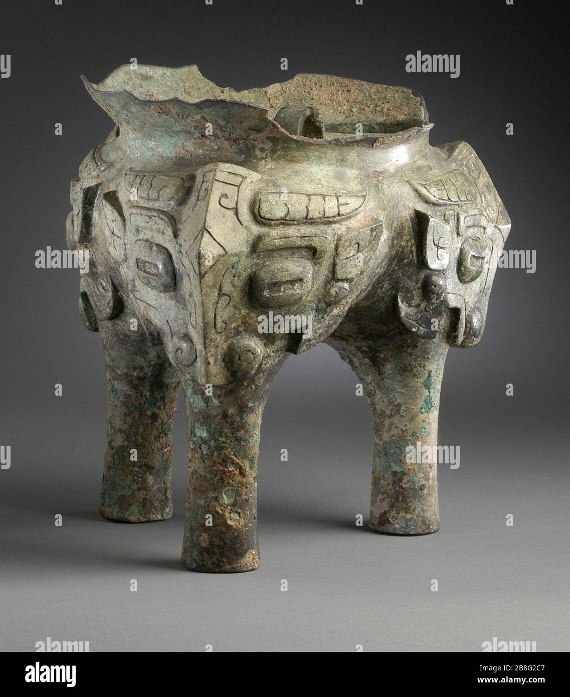 'Fragment of a Ritual Grain Steamer (Yan) with Masks; China, Late Shang dynasty, late Anyang phase, or early Western Zhou dynasty, about 1100-950 B.C.  Jewelry and Adornments; masks Cast bronze 8 1/8 x 7 1/4 in. (20.64 x 18.42 cm) Gift of Mr. and Mrs. Eric Lidow (AC1998.251.40) Chinese Art; between circa 1100 and circa 950 B.C.; ' Stock Photo