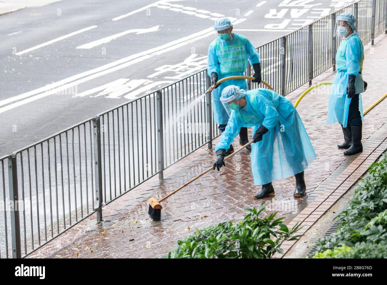Hong Kong, China. 22nd Mar 2020. Workers from the FEHD (The Food and Environmental Hygiene Department of the Hong Kong Government) disinfect the streets in Fortress Hill amid a rapid spike of Cover-19 virus infections. As the pandemic takes hold Hong Kongers, including students and travelers rushed back to the city before the border closure bringing the infection with them.Alamy Live news/Jayne Russell Credit: Jayne Russell/Alamy Live News Stock Photo