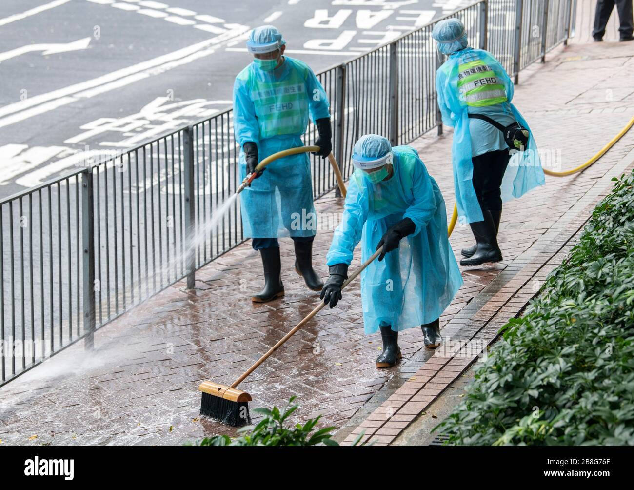 Hong Kong, China. 22nd Mar 2020. Workers from the FEHD (The Food and Environmental Hygiene Department of the Hong Kong Government) disinfect the streets in Fortress Hill amid a rapid spike of Cover-19 virus infections. As the pandemic takes hold Hong Kongers, including students and travelers rushed back to the city before the border closure bringing the infection with them.Alamy Live news/Jayne Russell Credit: Jayne Russell/Alamy Live News Stock Photo