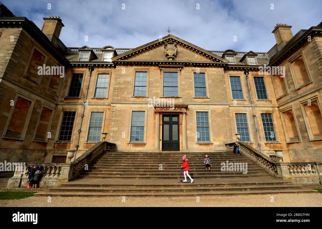 A general view of people walking around the grounds of Belton House in Grantham, which has been opened up free of charge after Boris Johnson ordered pubs, cafes, nightclubs, bars, restaurants, theatres, leisure centres and gyms to close to fight coronavirus. Stock Photo