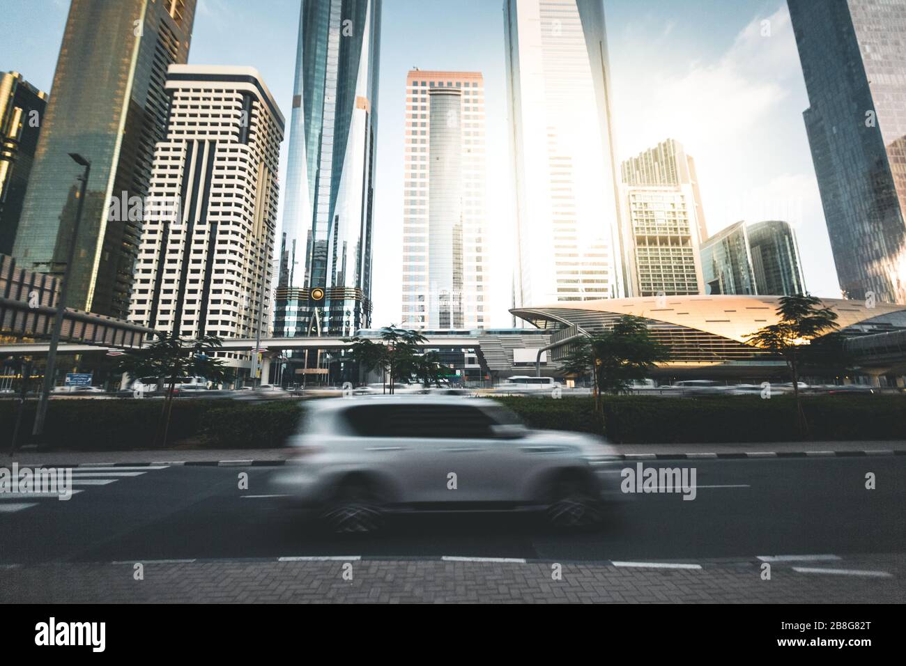 Passing car with skyscrapers in the background Dubai UAE Stock Photo