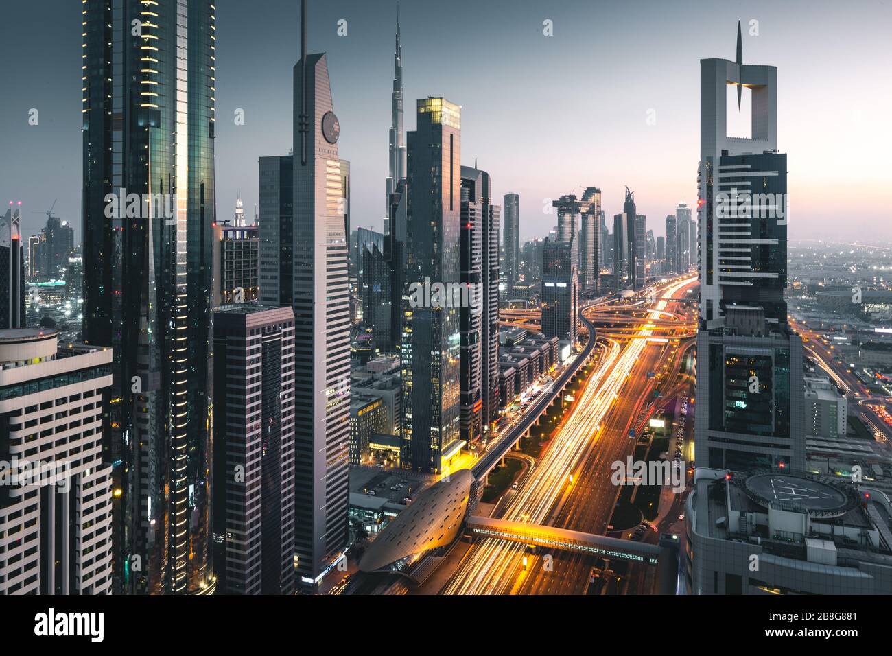 Long exposure view of traffic and skyline from rooftop at sunset Dubai