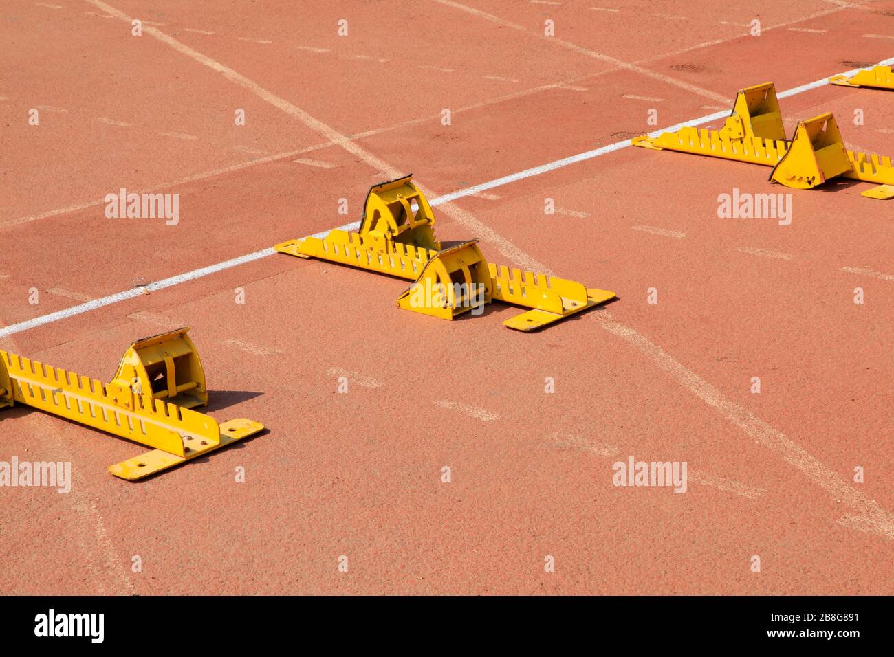 Brazilian athlete wearing flip flops crouching at the start position in  running blocks on the tiles of the Copacabana boardwalk Stock Photo - Alamy