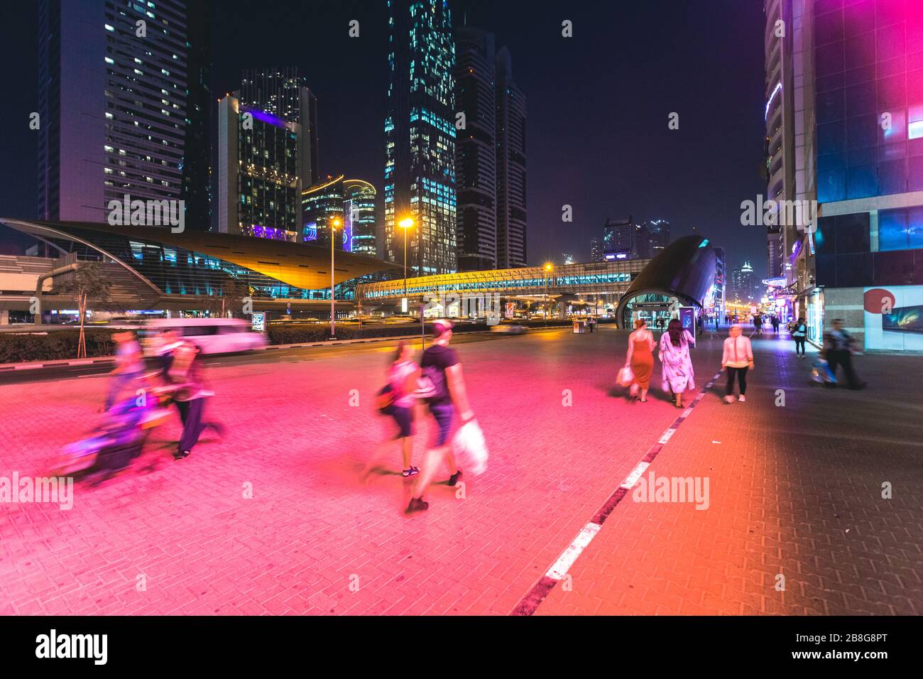 People walking in the street at night Dubai - UAE Stock Photo - Alamy