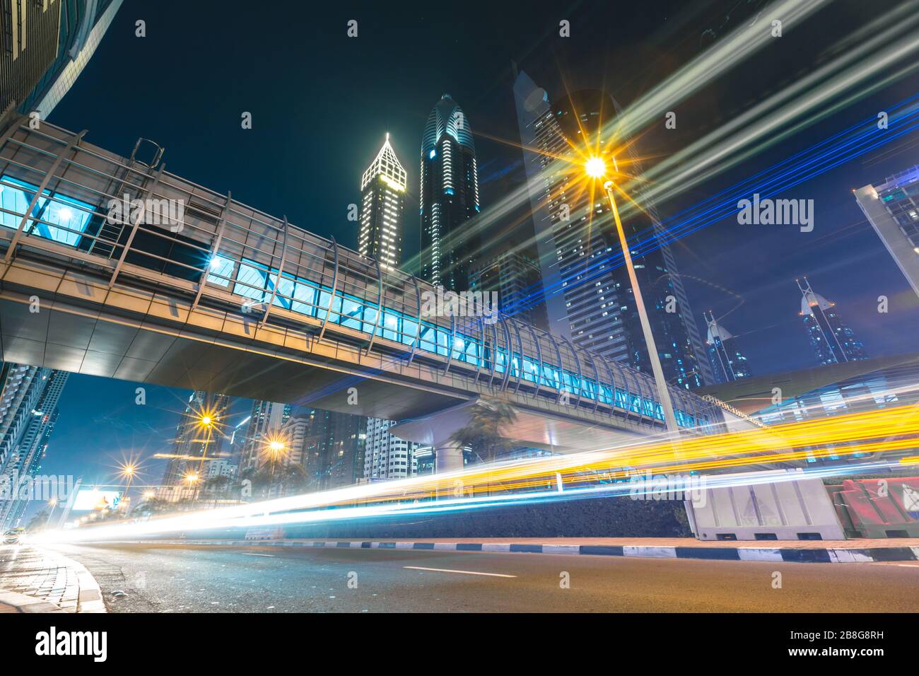 Long exposure of cars passing on highway in front of skyscrapers Dubai