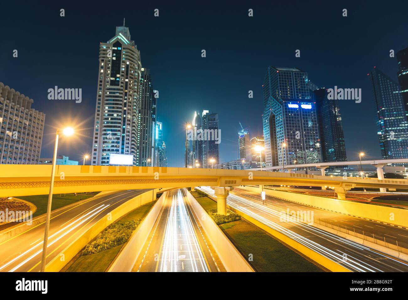 Long exposure of cars passing on highway at night in front of
