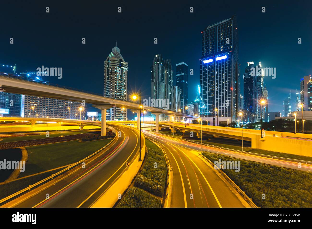 Long exposure of cars passing on highway at night in front of