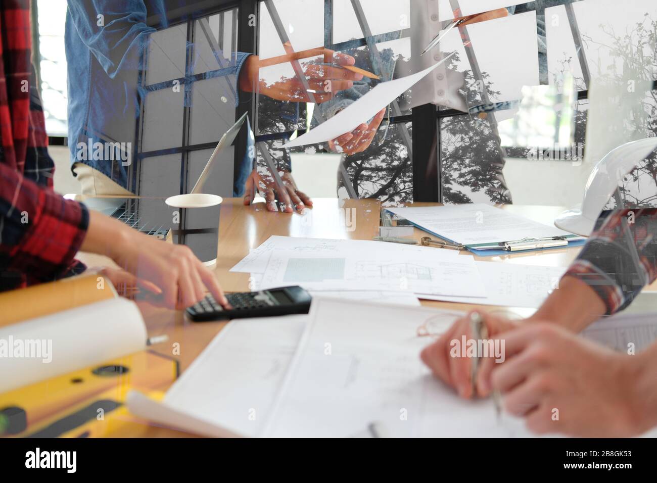 architect engineer interior designer team working discussing on house blueprint of real estate project in meeting. building construction teamwork conc Stock Photo