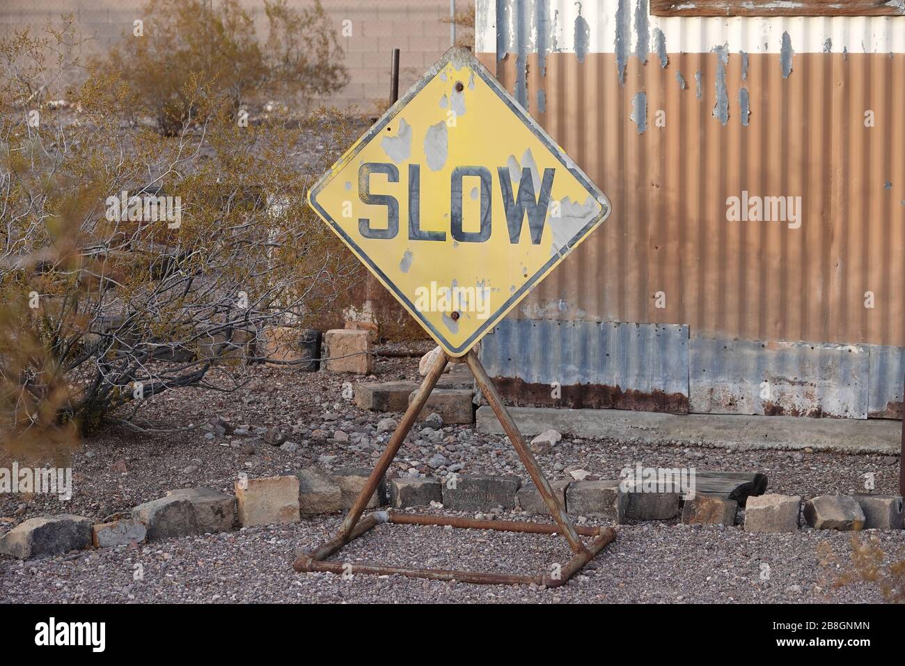 Old road sign 'Slow' Stock Photo