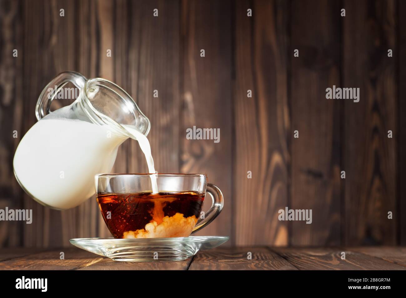 flying jug pouring milk into cup Stock Photo Alamy