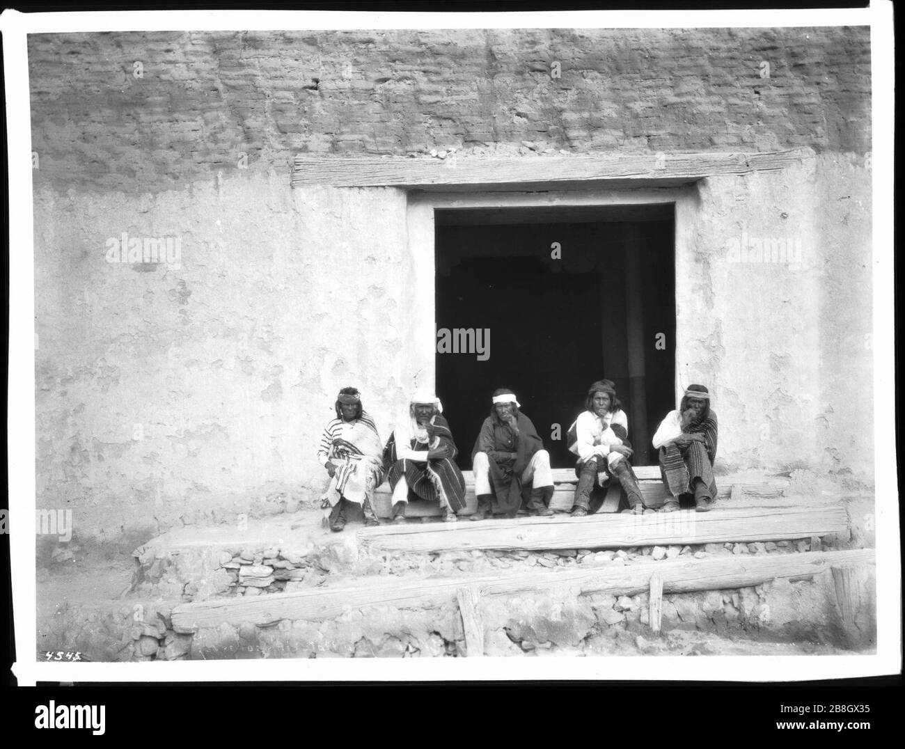 Governor Eusebius and his staff sitting on the steps of the old church, Acoma Pueblo, New Mexico, 1886 Stock Photo