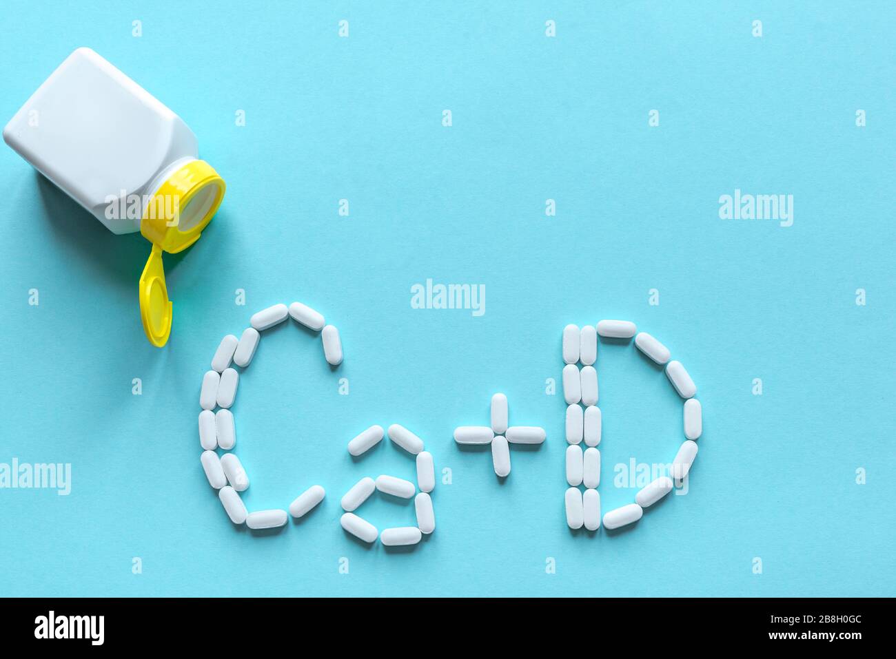 Calcium and Vitamin D Generic Tablets. White pills forming shape to Ca