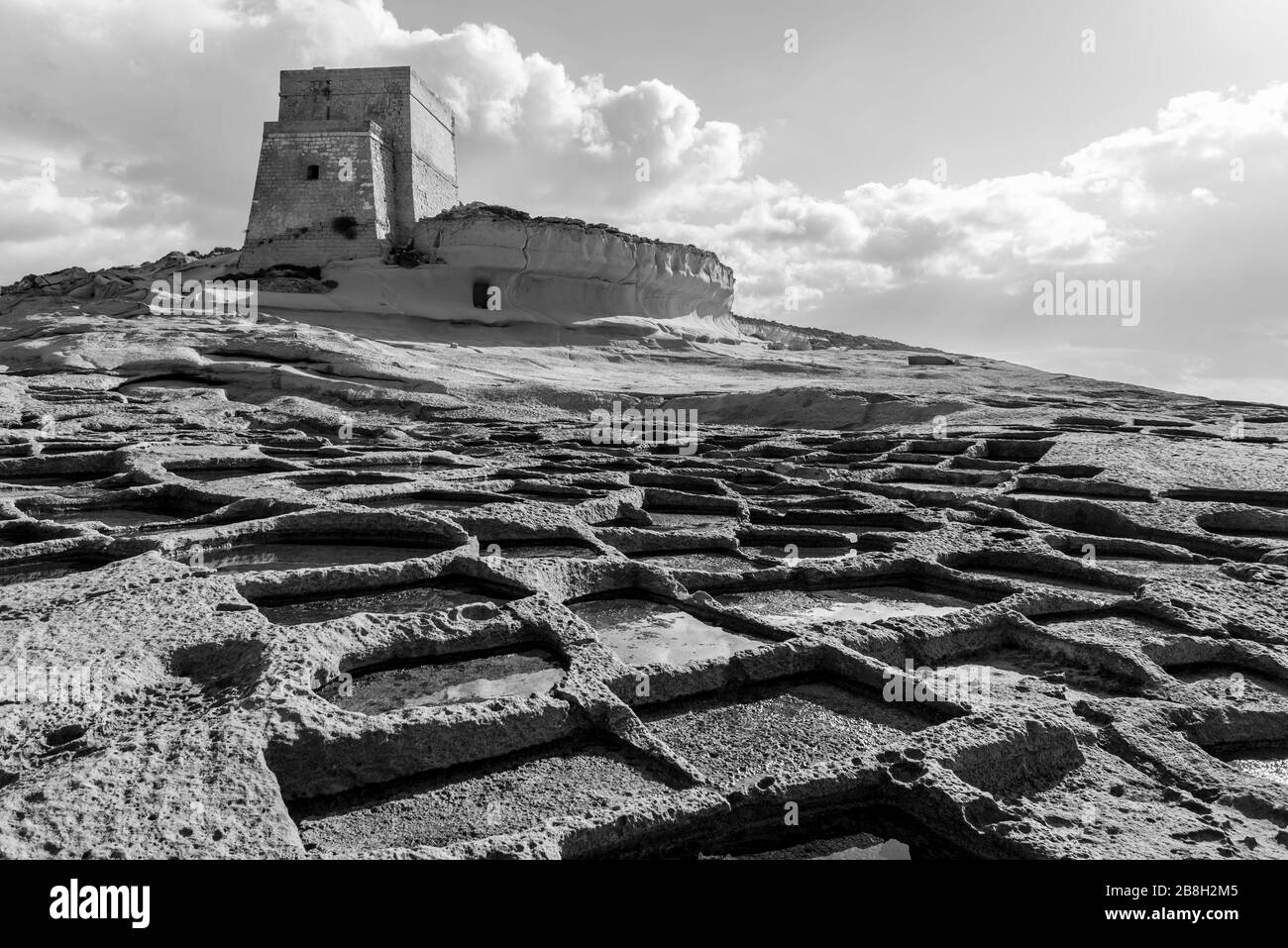 Salt Pans and Xlendi Tower on Ras il-Bajda, Gozo, Malta Stock Photo