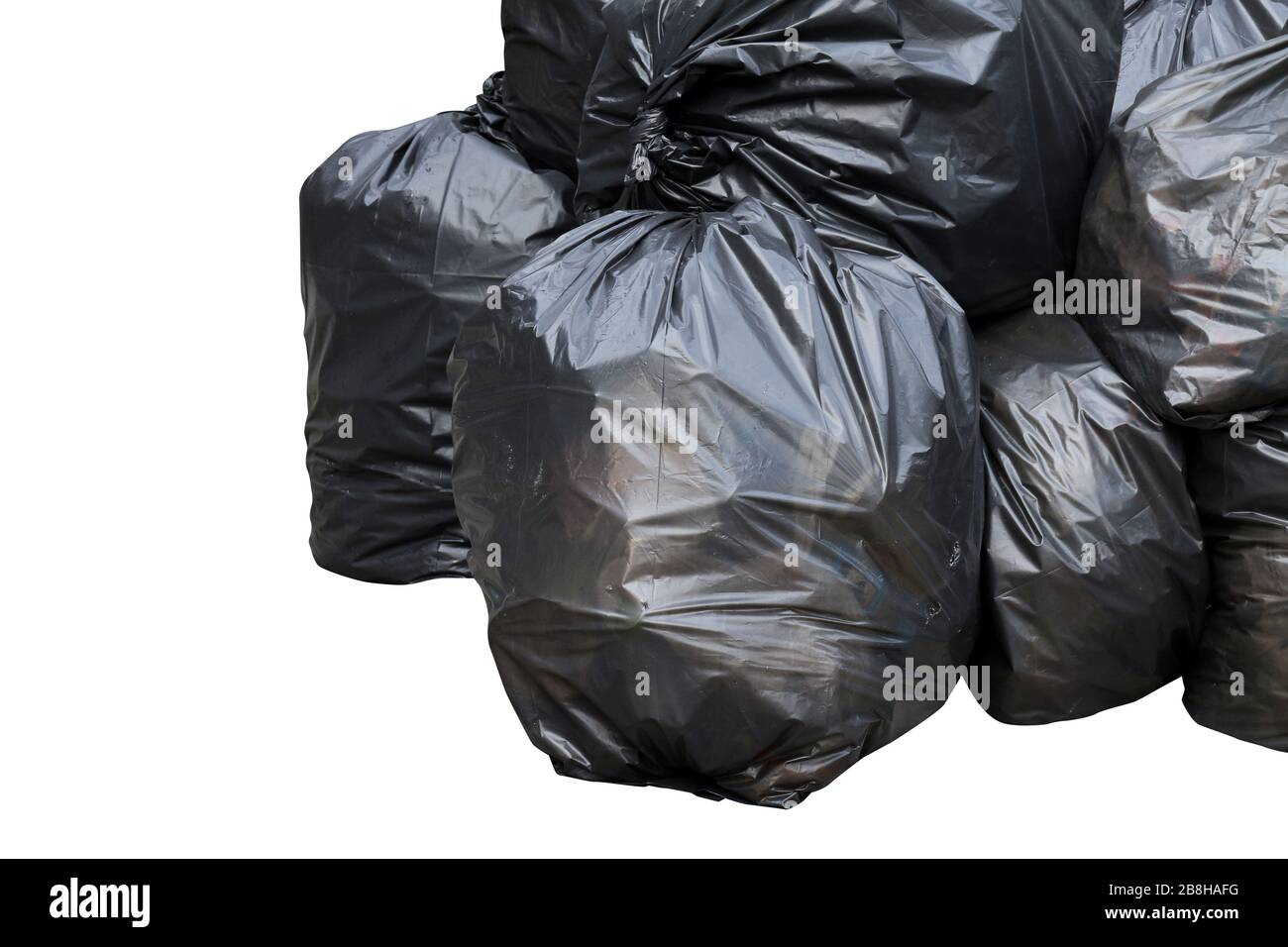 a pile of garbage bags lying on grass a garbage bin and a pile of cut  papaya tree Stock Photo - Alamy