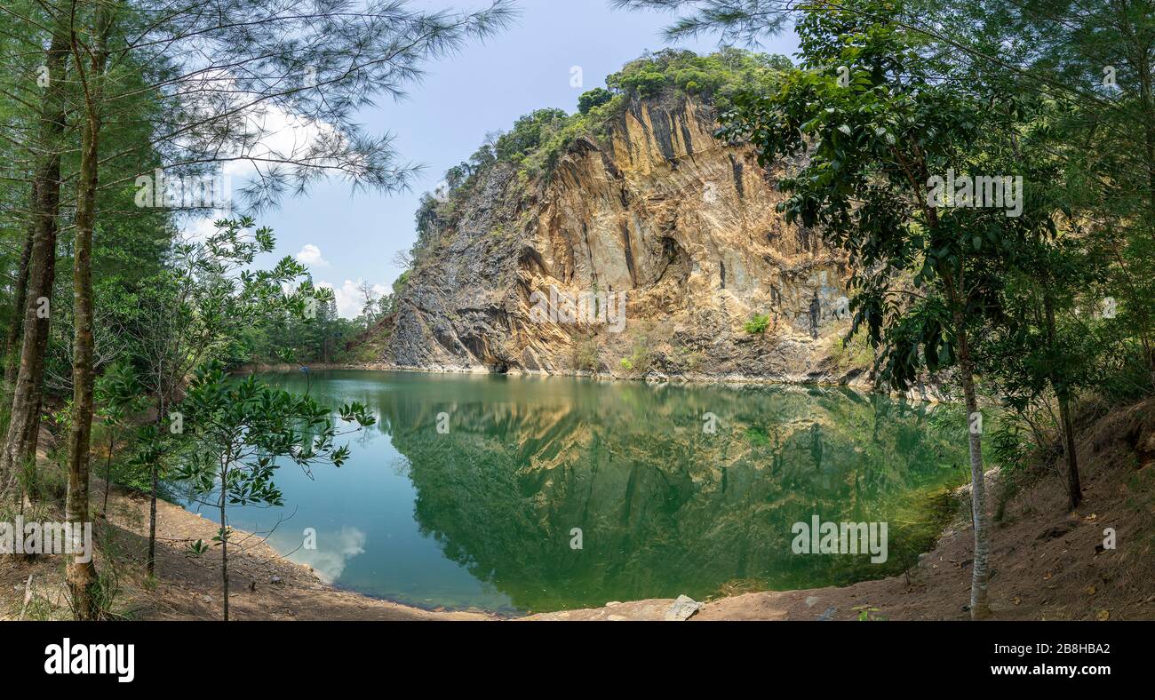 Emerald green pond Caused by digging limestone mines Blue sky and white