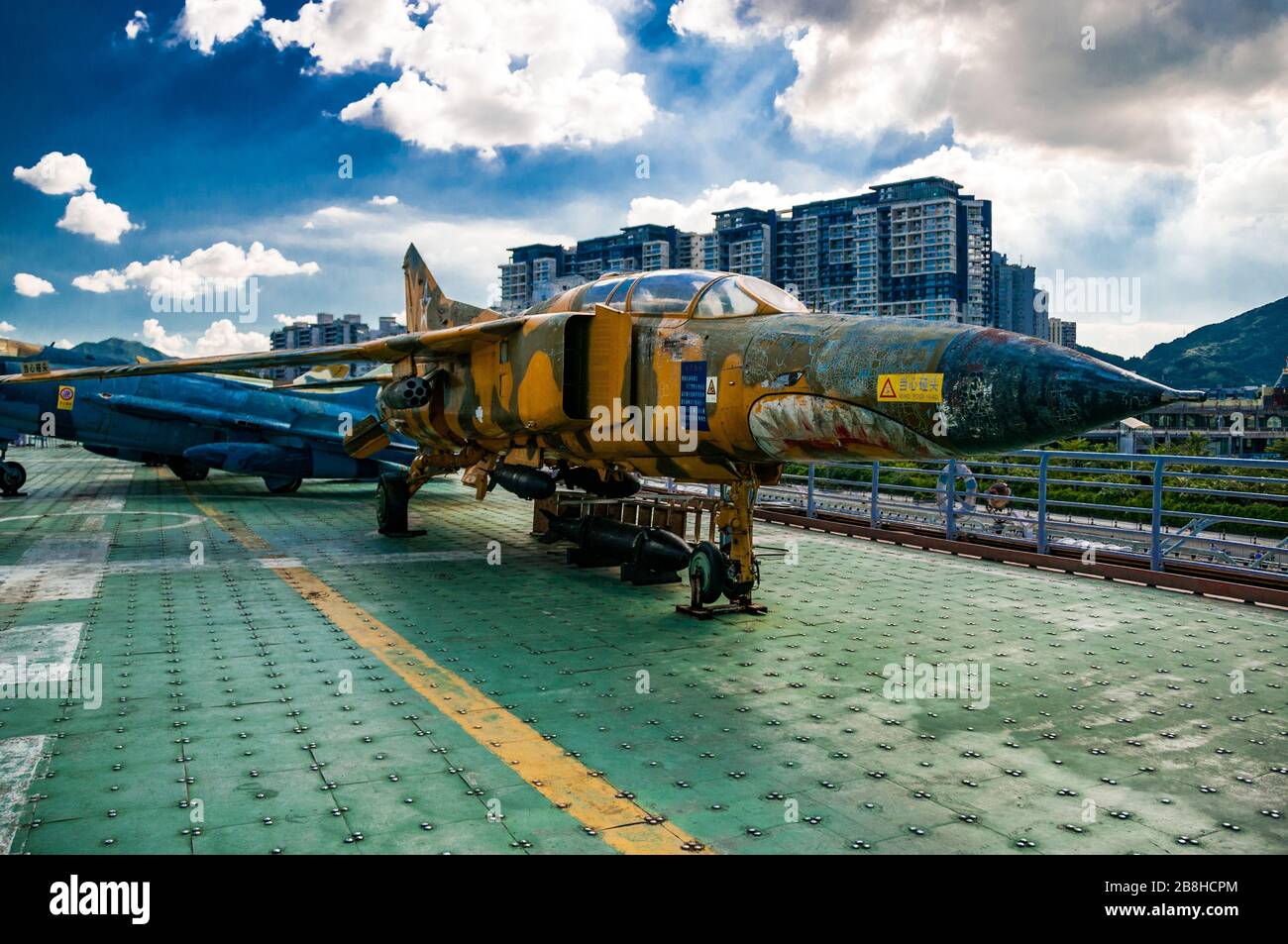 Minsk is an old Soviet aircraft carrier in use as a military theme park in Yantian, Shenzhen, China with a former Egyptian MiG-23U trainer on the deck Stock Photo