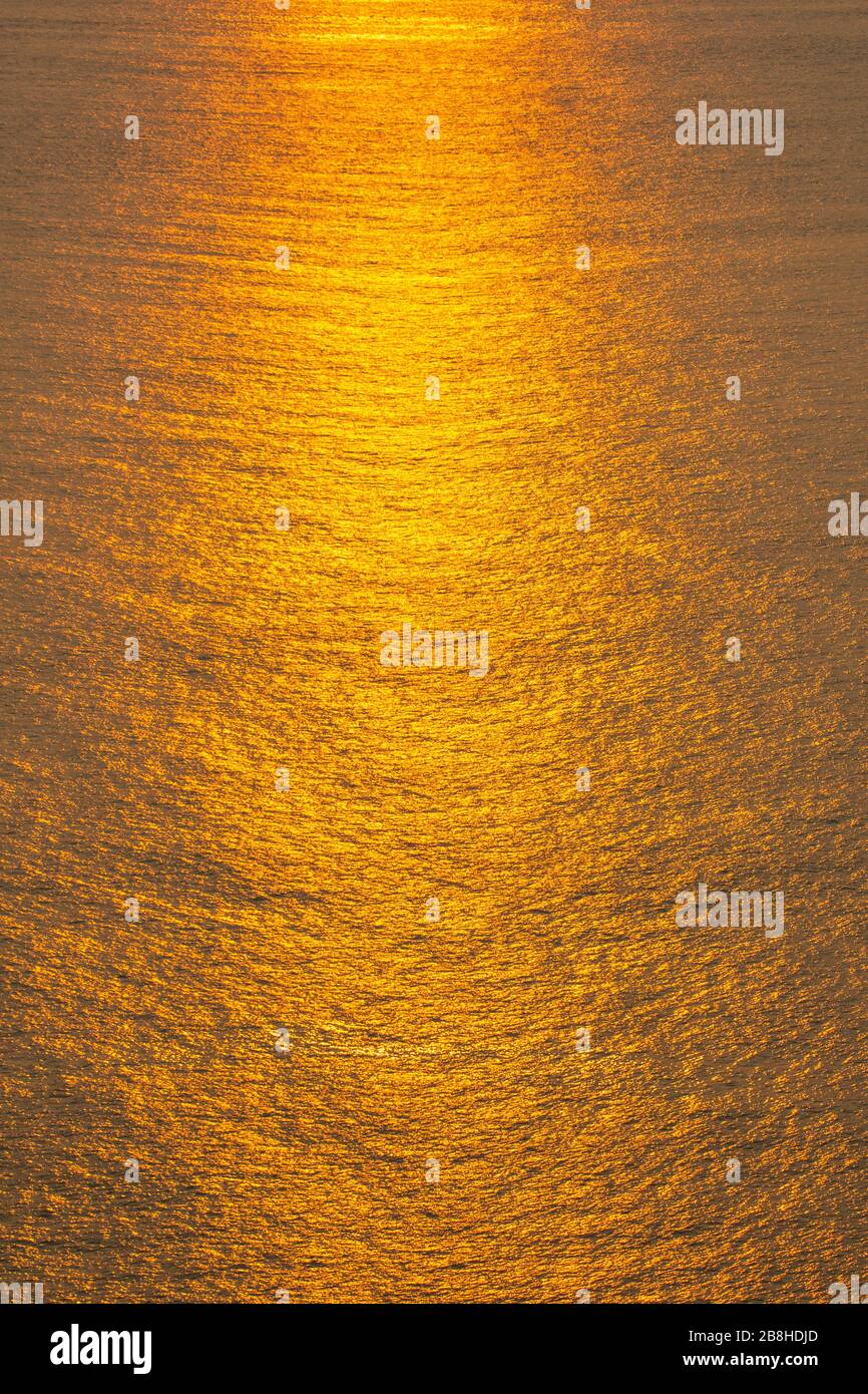 Sunset The sea surface reflects the sunlight in gold Stock Photo - Alamy