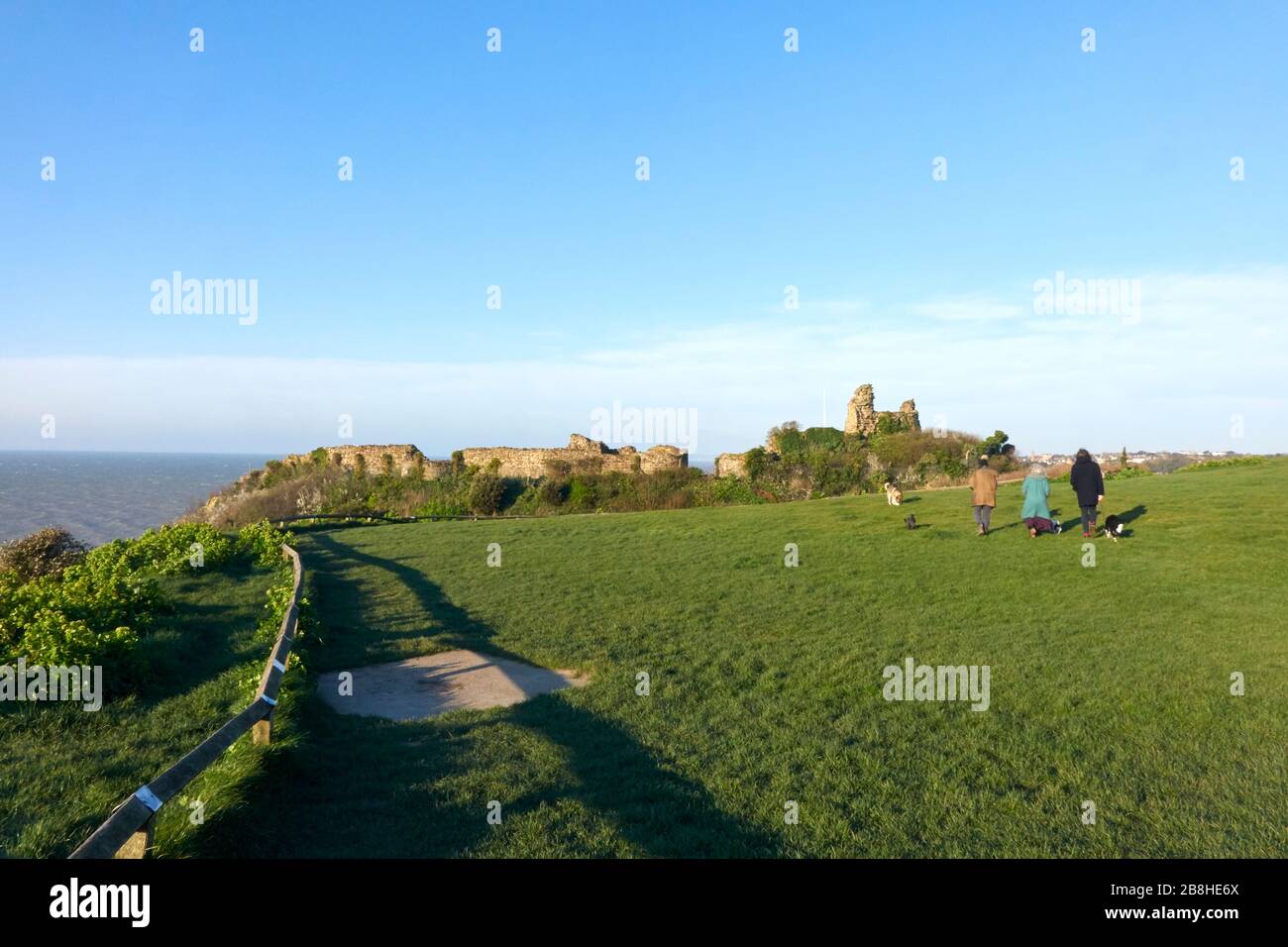 Hastings, East Sussex, UK. 22nd Mar, 2020. At Hastings Castle, a few dog walkers take advantage of a bright sunny spring day to get some permitted exercise in the quiet early morning on the 1st national lockdown 2020. Stock Photo