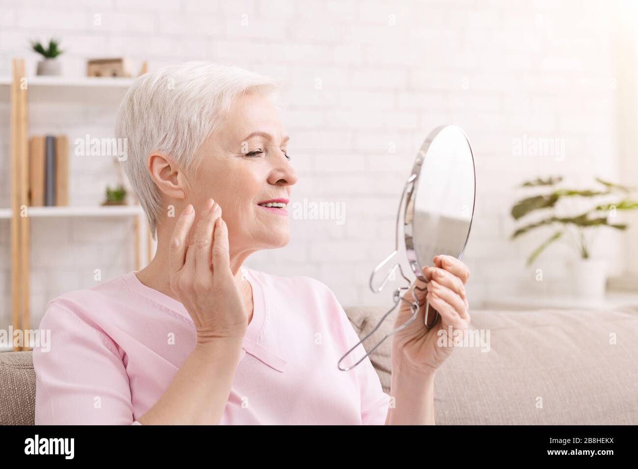 Woman massaging face mature hi-res stock photography and images - Alamy