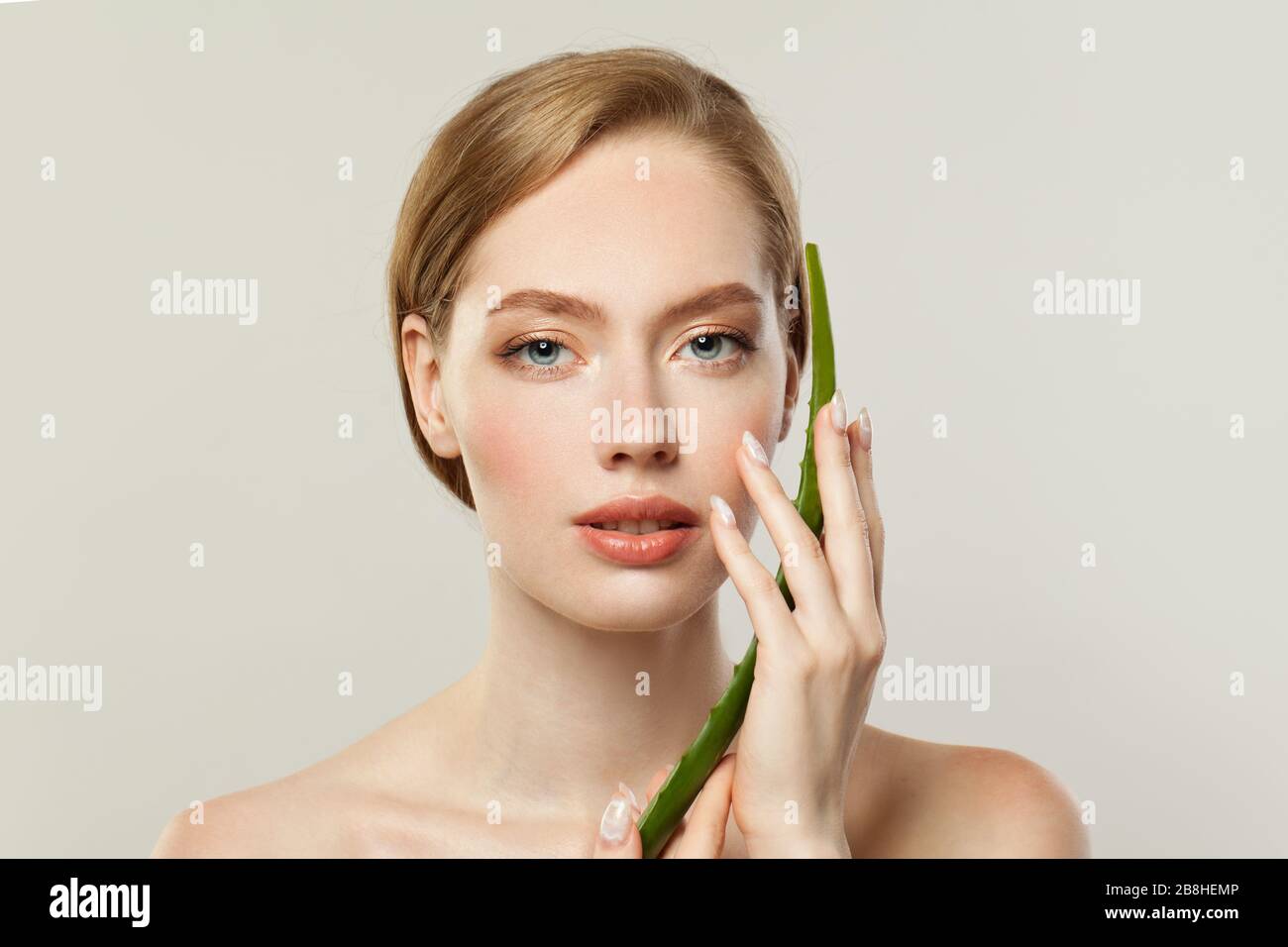 Perfect young woman face and aloe vera leaf on white background Stock Photo Alamy