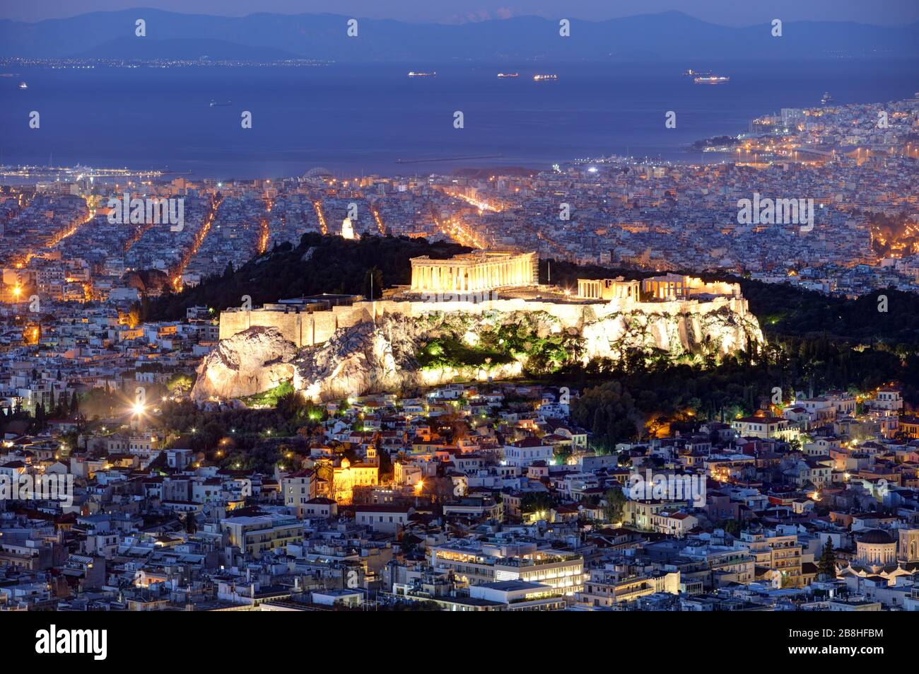 Athens skyline panorama with Acropolis in Greece from peak Lycabettus at night Stock Photo