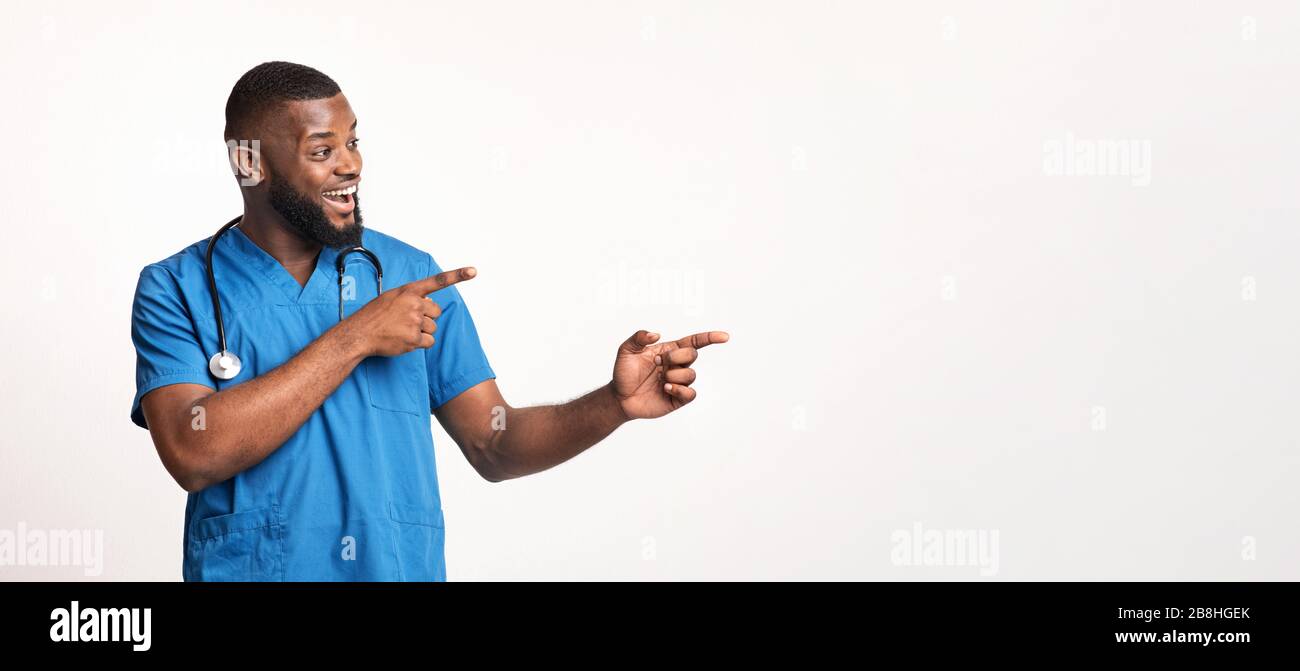 Young african surgeon showing empty space for advertisement Stock Photo