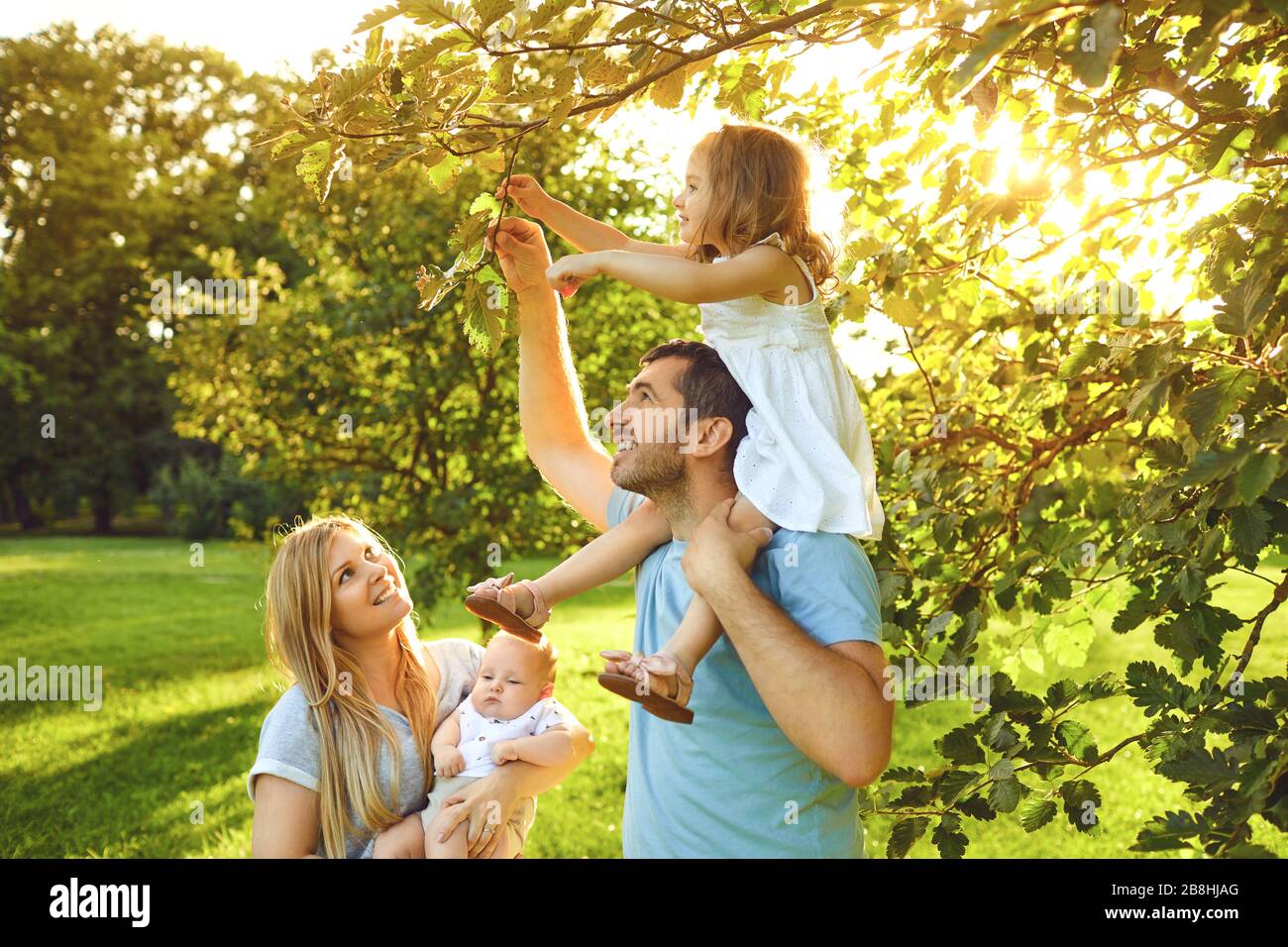 Happy young family with children in the park Stock Photo