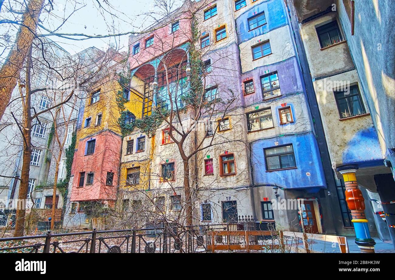 VIENNA, AUSTRIA - FEBRUARY 19, 2019: The courtyard of Hundertwasser haus with small garden amid the tall house walls, on February 19 in Vienna Stock Photo