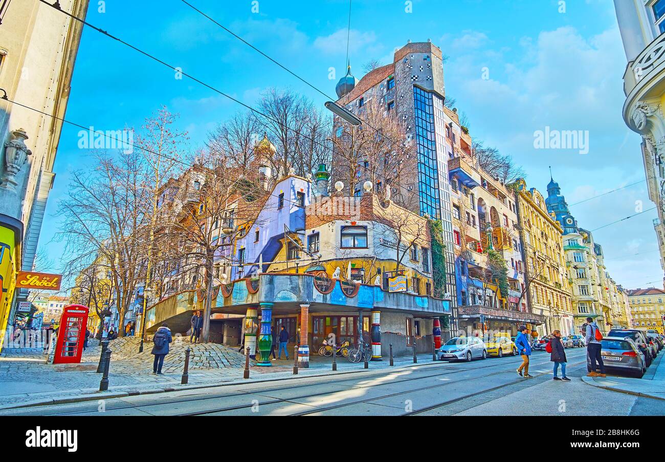 VIENNA, AUSTRIA - FEBRUARY 19, 2019: The corner of outstanding Expressionist-style Hundertwasser haus, decorated with porcelain pillars and different Stock Photo
