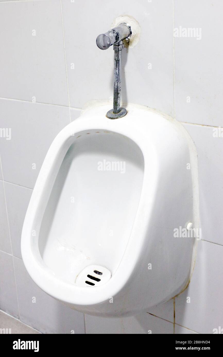 urinals white, close up white urinals in men's bathroom, white ceramic urinals for men in toilet room Stock Photo