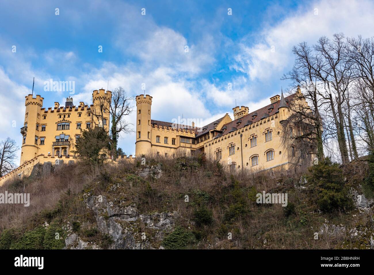 Beautiful view of the famous Hohenschwangau Castle on a sunny day in winter, with blue sky and cloud background, Schwangau, Bavaria, Germany Stock Photo