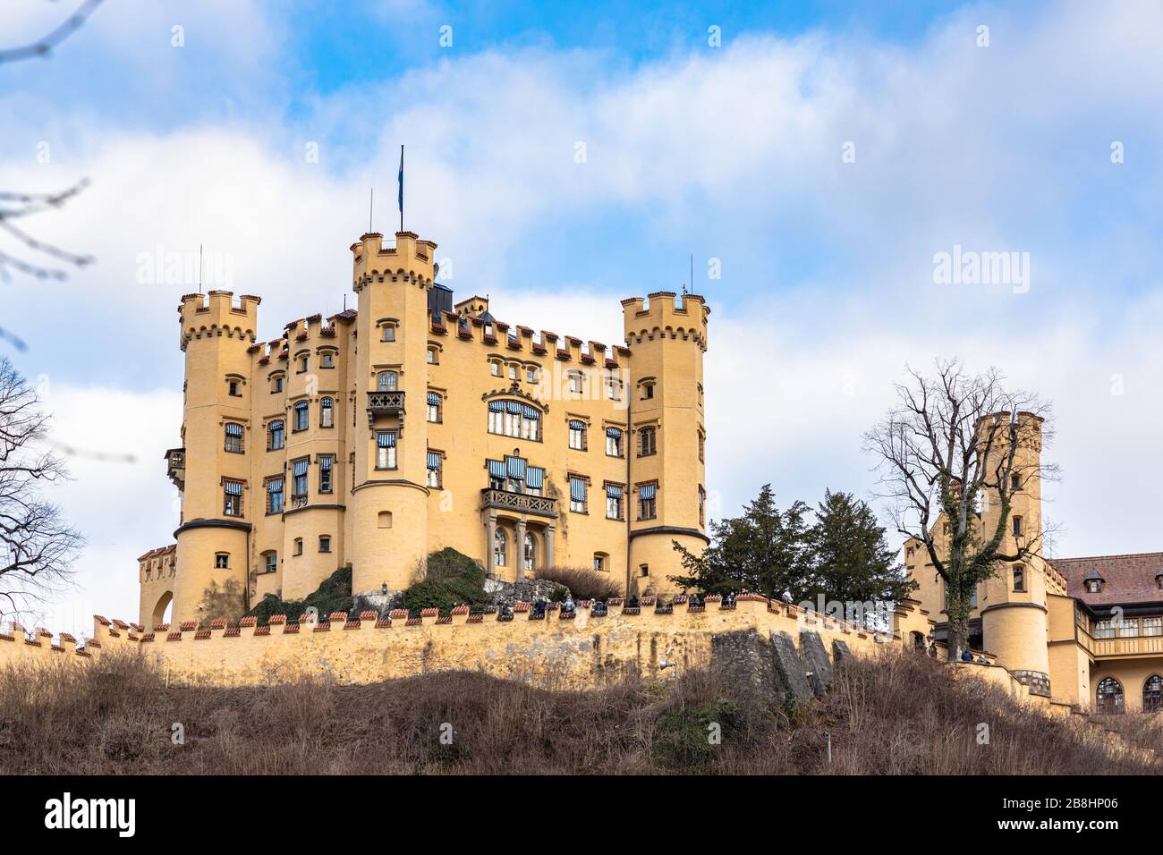 Beautiful view of the famous Hohenschwangau Castle on a sunny day in winter, with blue sky and cloud background, Schwangau, Bavaria, Germany Stock Photo