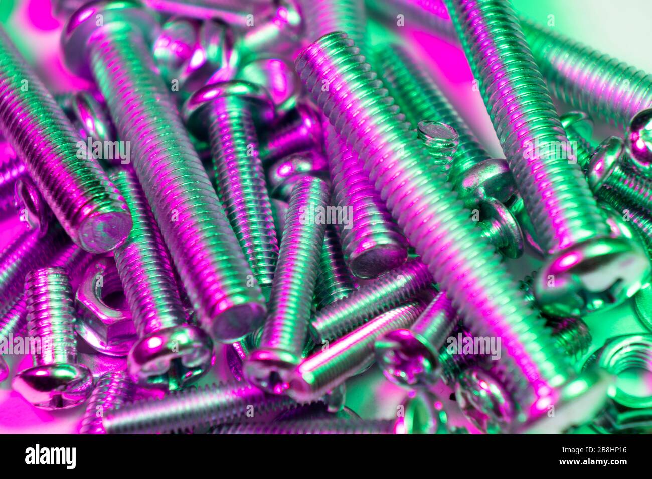 Metal bolts and nuts in a row background. Chromed screw bolts and nuts