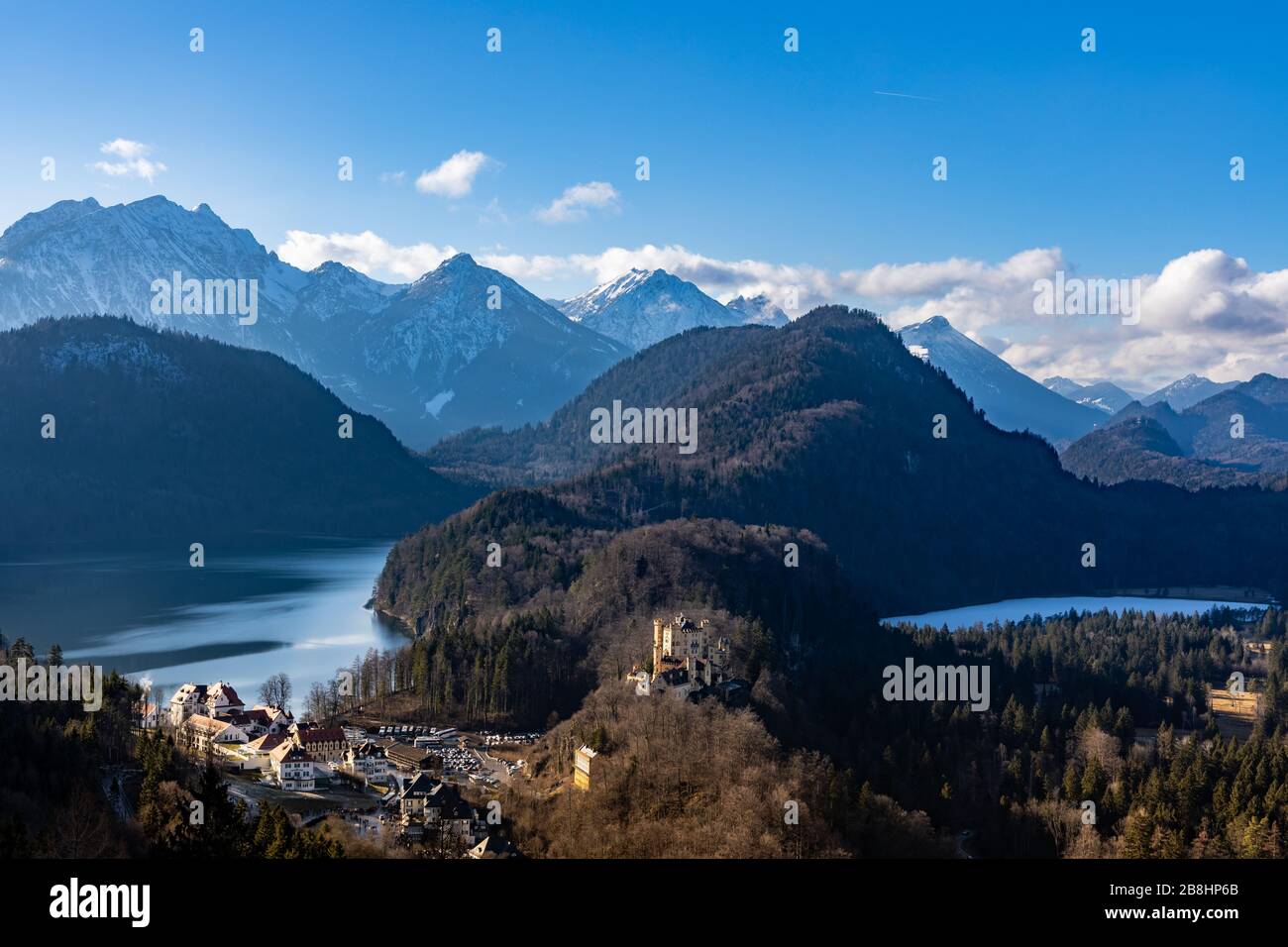 Panorama view of the Bavarian Alps and Lake with the famous Hohenschwangau Castle and Alpsee lake, Schwansee lake on a sunny day in winter, Schwangau, Stock Photo