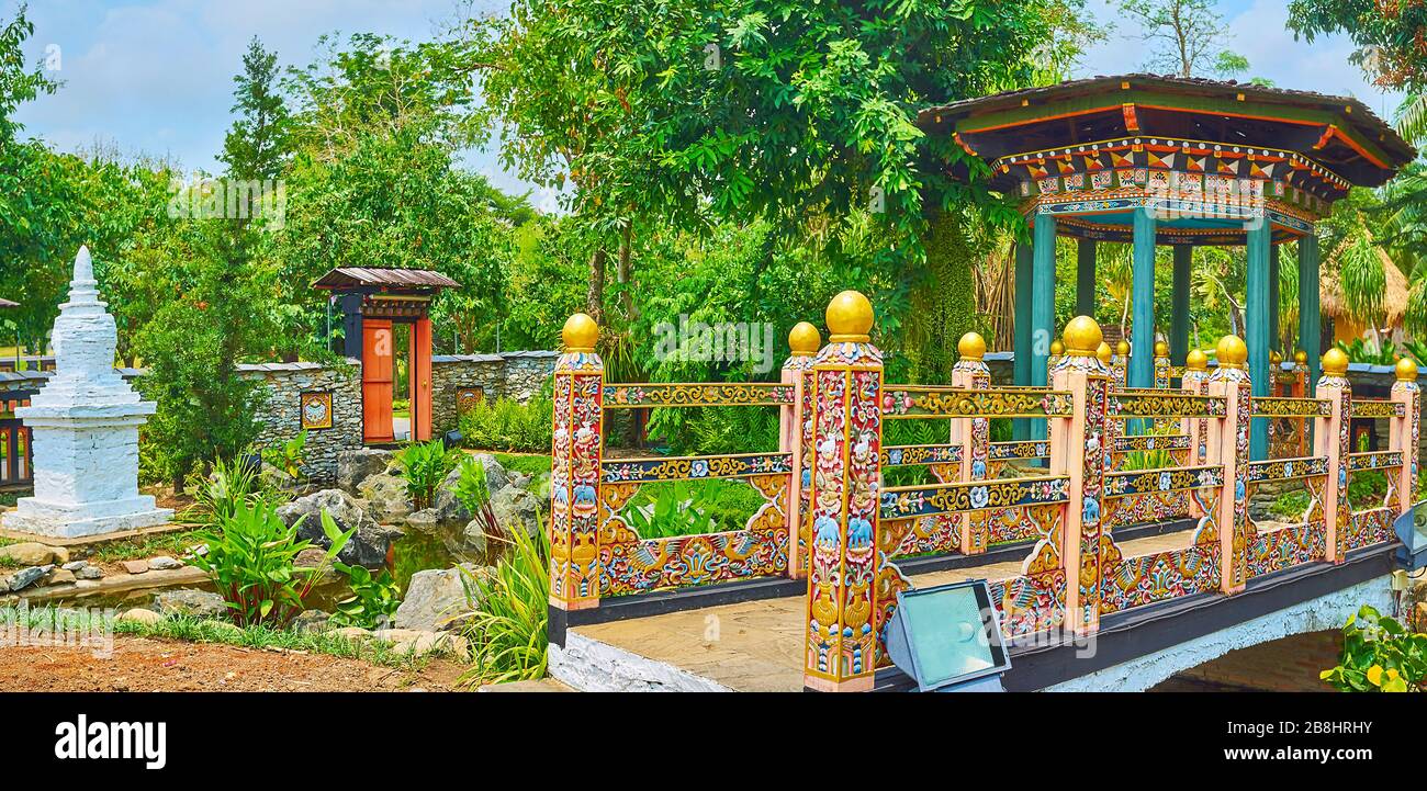 The carved wooden bridge, decorated with fine floral pattern of traditional Thai (golden shower flower) and Bhutanese (blue poppy flower) elements, lo Stock Photo