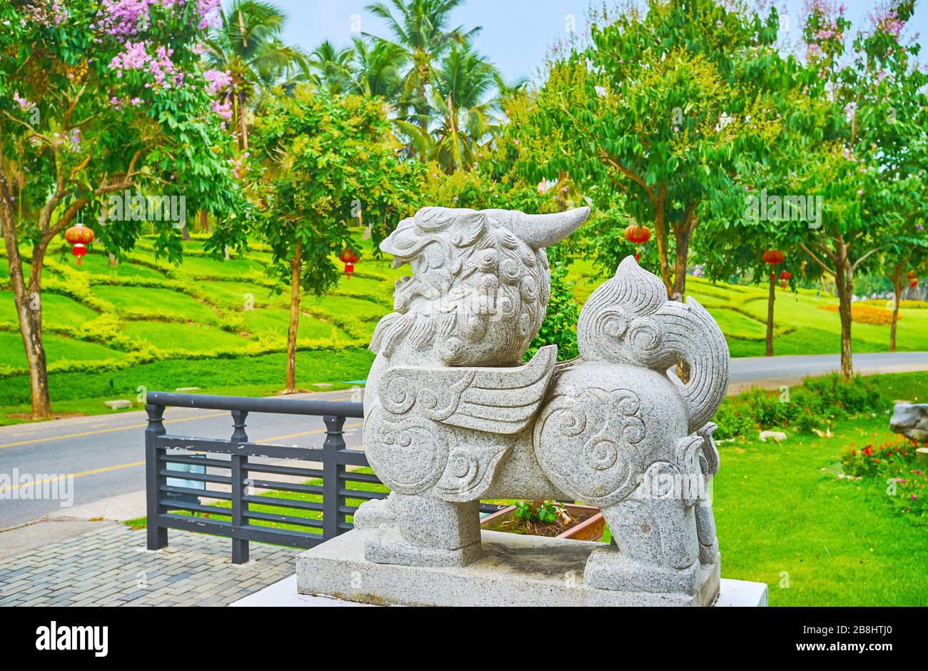 The carved stone sculpture of Pixiu - traditional Chinese mythic creature, partly lion and partly dragon, located at the China garden of Rajapruek par Stock Photo