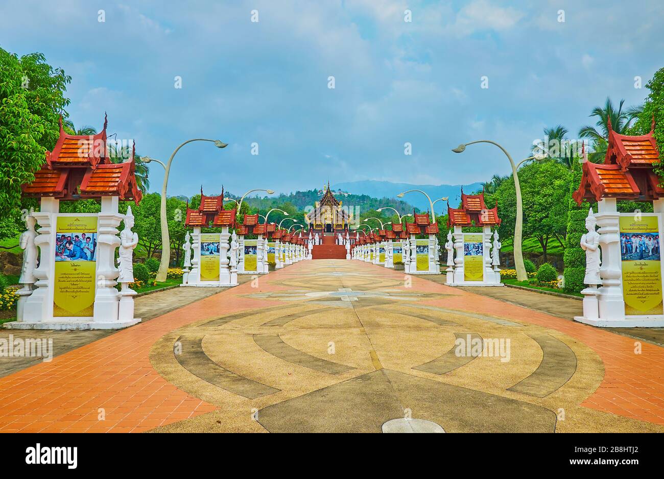 CHIANG MAI, THAILAND - MAY 7, 2019: The long alley with mosaic floor and many info stands leads to the Royal Pavilion of Rajapruek park, on May 7 in C Stock Photo