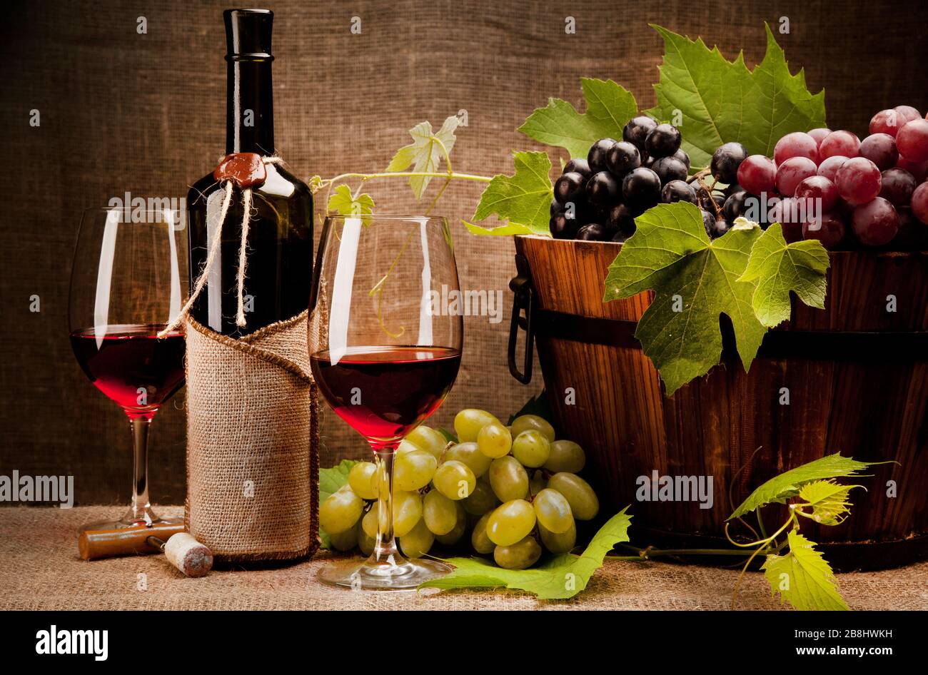 Still life with wine bottles, glasses and grapes Stock Photo - Alamy