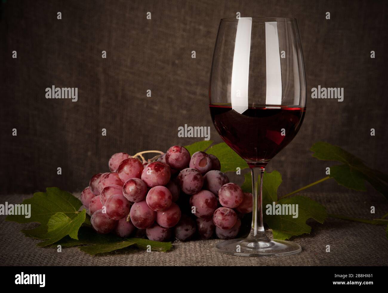 Still life with wine bottles, glasses and grapes Stock Photo - Alamy